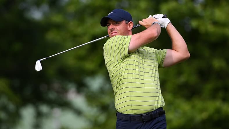 May 19, 2022; Tulsa, Oklahoma, USA; Rory McIlroy plays his shot on to the 14th tee during the first round of the PGA Championship golf tournament. Mandatory Credit: Orlando Ramirez-USA TODAY Sports
