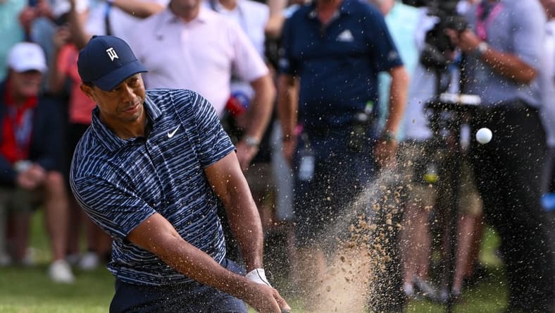 May 19, 2022; Tulsa, Oklahoma, USA; Tiger Woods plays his shot from the bunker on the 13th green during the first round of the PGA Championship golf tournament. Mandatory Credit: Orlando Ramirez-USA TODAY Sports