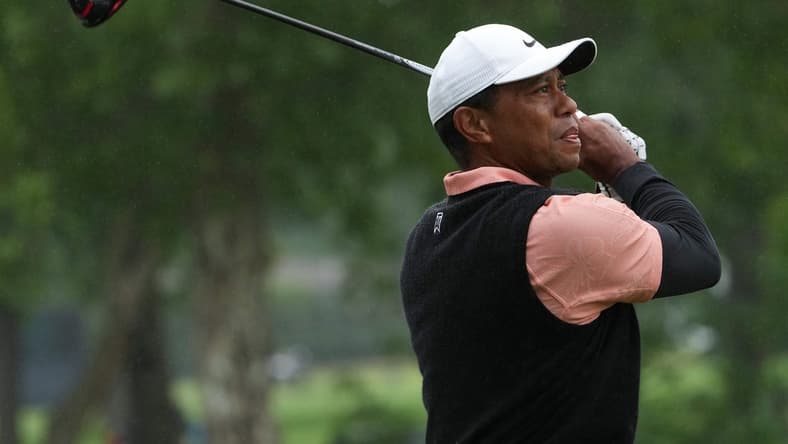 May 21, 2022; Tulsa, OK, USA; Tiger Woods plays his shot from the ninth tee as rain falls during the third round of the PGA Championship golf tournament at Southern Hills Country Club. Mandatory Credit: Michael Madrid-USA TODAY Sports