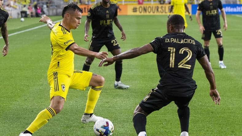 May 21, 2022; Columbus, Ohio, USA; Columbus Crew midfielder Lucas Zelarayan (10) cuts inside Los Angeles FC defender Diego Palacios (12) in the first half at Lower.com. Field Mandatory Credit: Greg Bartram-USA TODAY Sports