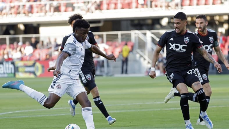 May 21, 2022; Washington, District of Columbia, USA; Toronto FC forward Deandre Kerr (29) shoots the ball as D.C. United defender Tony Alfaro (93) defends in the first half at Audi Field. Mandatory Credit: Geoff Burke-USA TODAY Sports