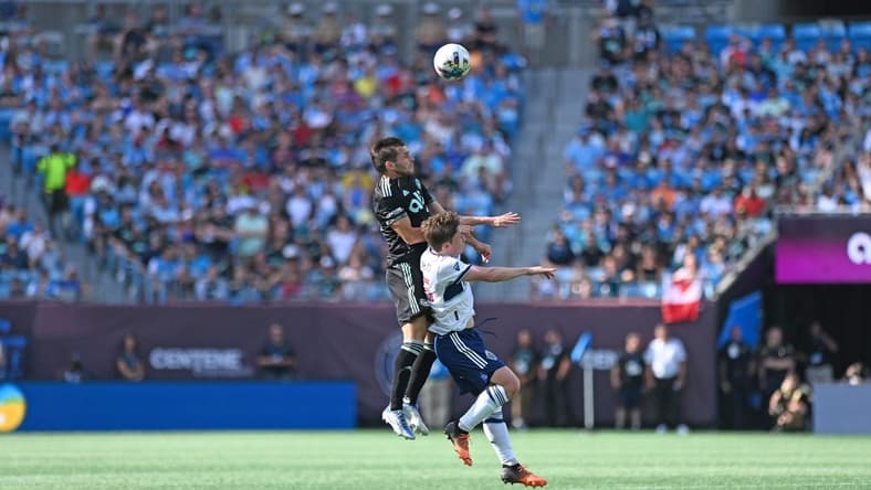 May 22, 2022; Charlotte, North Carolina, USA; Charlotte FC midfielder Brandt Bronico (13) heads the ball against Vancouver Whitecaps FC at Bank of America Stadium. Mandatory Credit: Griffin Zetterberg-USA TODAY Sports