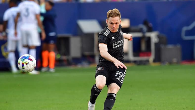 May 22, 2022; Carson, California, USA; Houston Dynamo forward Tyler Pasher (19) scores a goal against the Los Angeles Galaxy during the second half at Dignity Health Sports Park. Mandatory Credit: Gary A. Vasquez-USA TODAY Sports