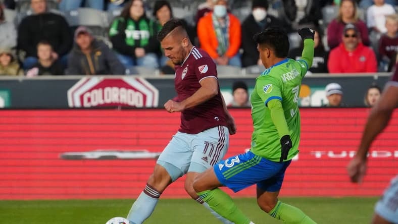 May 22, 2022; Commerce City, Colorado, USA; Colorado Rapids forward Diego Rubio (11) kicks the ball past Seattle Sounders defender Xavier Arreaga (3) in the second half at Dick's Sporting Goods Park. Mandatory Credit: Ron Chenoy-USA TODAY Sports