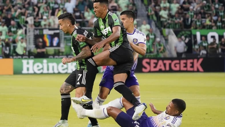 May 22, 2022; Austin, Texas, USA; Austin FC forward Sebastian Driussi (7) and defender Julio Cascante (18) get tangled up with Orlando City midfielder Junior Urso (11) and midfielder Cesar Araujo (5) during the second half at Q2 Stadium. Mandatory Credit: Scott Wachter-USA TODAY Sports
