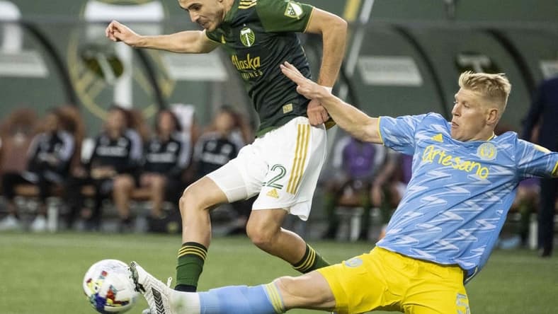 May 22, 2022; Portland, Oregon, USA; Philadelphia Union defender Jakob Glesnes (5) defends Portland Timbers midfielder Cristhian Paredes (22) during the first half at Providence Park. Mandatory Credit: Troy Wayrynen-USA TODAY Sports