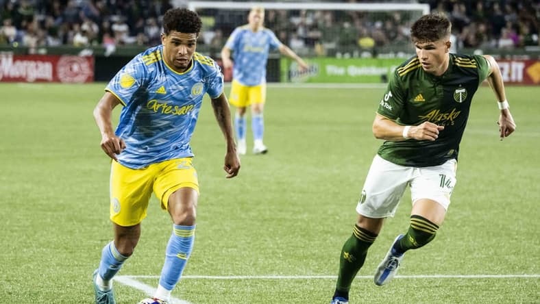 May 22, 2022; Portland, Oregon, USA; Philadelphia Union defender Nathan Harriel (26) controls a pass during the second half against Portland Timbers defender Justin Rasmussen (14) at Providence Park. Philadelphia Union won 2-0. Mandatory Credit: Troy Wayrynen-USA TODAY Sports