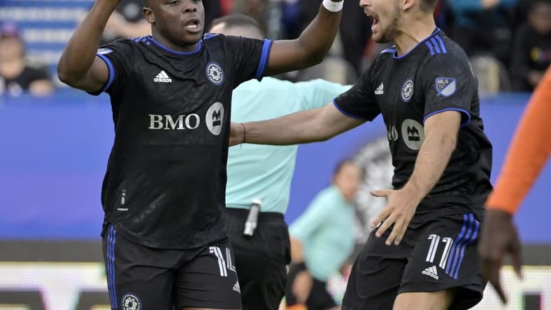 May 25, 2022; Montreal, Quebec, Canada; CF Montreal forward Sunusi Ibrahim (14) celebrates with teammate midfielder Matko Miljevic (11) after scoring a goal against the Forge FC  during the first half at Stade Saputo. Mandatory Credit: Eric Bolte-USA TODAY Sports