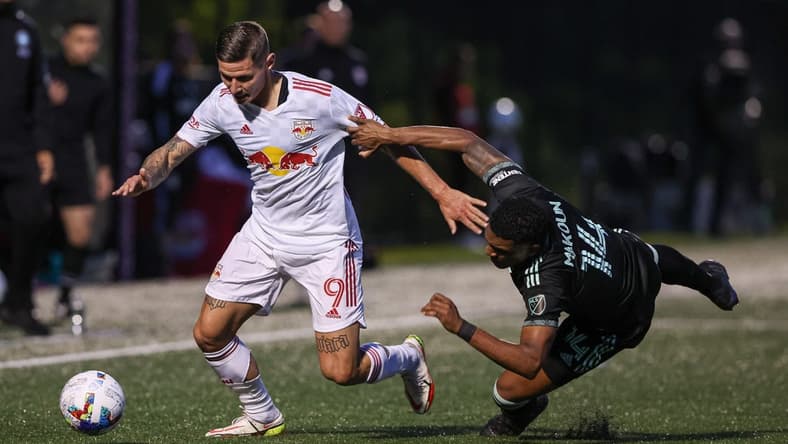 May 25, 2022; Montclair, New Jersey, USA; New York Red Bulls forward Patryk Klimala (9) plays the ball against Charlotte FC defender Christian Makoun (14) during the first half at Montclair State University Soccer Park. Mandatory Credit: Vincent Carchietta-USA TODAY Sports