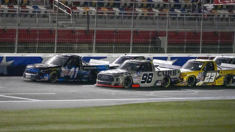 May 27, 2022; Concord, North Carolina, USA; NASCAR Camping World Truck Series driver Ross Chastain (41) moves ahead in the final restart with three laps to go ahead of driver Christian Eckes (98) during the Education Lottery 200 at Charlotte Motor Speedway. Mandatory Credit: Jim Dedmon-USA TODAY Sports