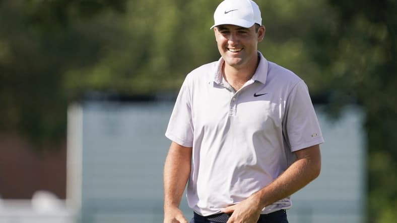 May 28, 2022; Fort Worth, Texas, USA; Scottie Scheffler smiles on the green after making a birdie on the 18th hole during the third round of the Charles Schwab Challenge golf tournament. Mandatory Credit: Raymond Carlin III-USA TODAY Sports