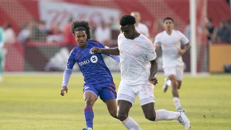May 28, 2022; Toronto, Ontario, CAN; Chicago Fire defender Carlos Teran (23) battles for the ball against Toronto FC forward Jayden Nelson (11) during the first half at BMO Field. Mandatory Credit: Nick Turchiaro-USA TODAY Sports
