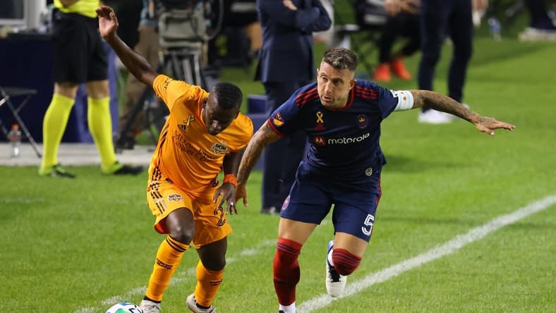 Sep 23, 2020; Chicago, Illinois, USA; Chicago Fire defender Francisco Calvo (5) knocks the ball away from Houston Dynamo forward Carlos Darwin Quintero (23) during the second half at Soldier Field. Mandatory Credit: Mike Dinovo-USA TODAY Sports