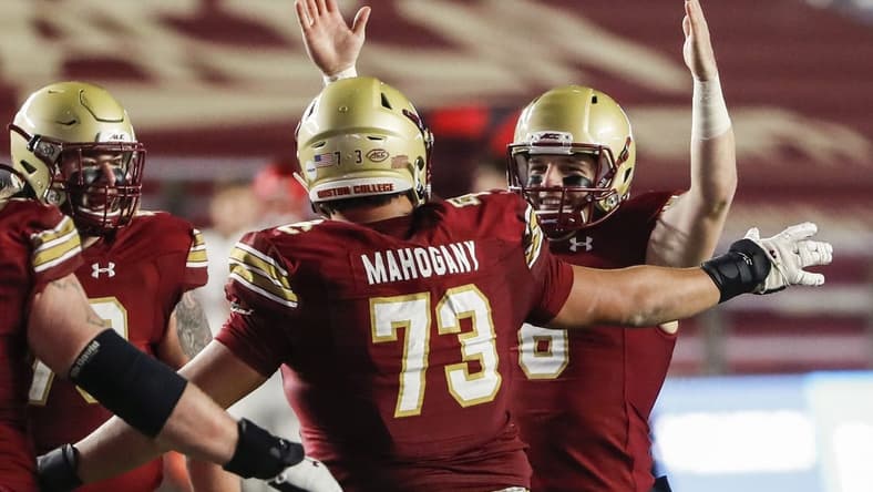 Nov 28, 2020; Chestnut Hill, Massachusetts, USA; Boston College Eagles quarterback Dennis Grosel (6) celebrates a touchdown pass with offensive lineman Christian Mahogany (73) against the Louisville Cardinals during the second half at Alumni Stadium. Mandatory Credit: Winslow Townson-USA TODAY Sports