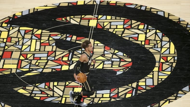 Apr 9, 2021; Atlanta, Georgia, USA; Atlanta Hawks guard Trae Young (11) dribbles across the logo against the Chicago Bulls in the second quarter at State Farm Arena. Mandatory Credit: Brett Davis-USA TODAY Sports