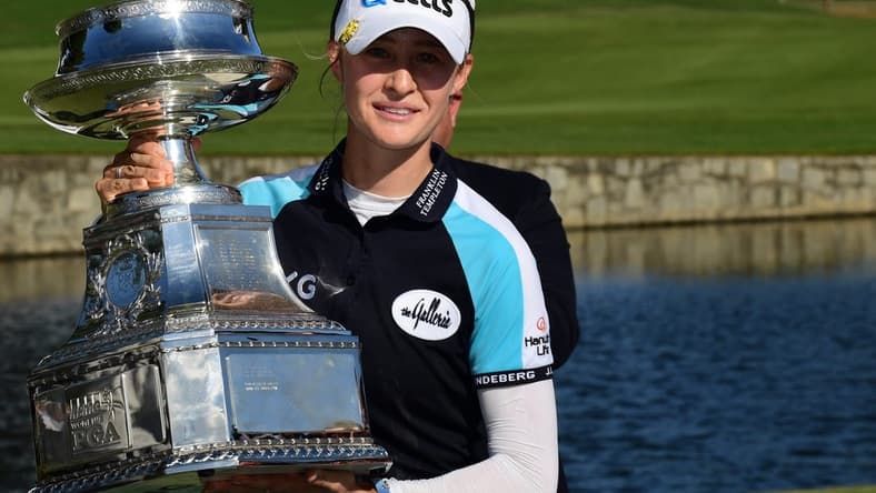 Jun 27, 2021; John's Creek, Georgia, USA; Nelly Korda holds the championship trophy as she celebrates winning the KPMG Women's PGA Championship golf tournament at the Atlanta Athletic Club. Mandatory Credit: Adam Hagy-USA TODAY Sports