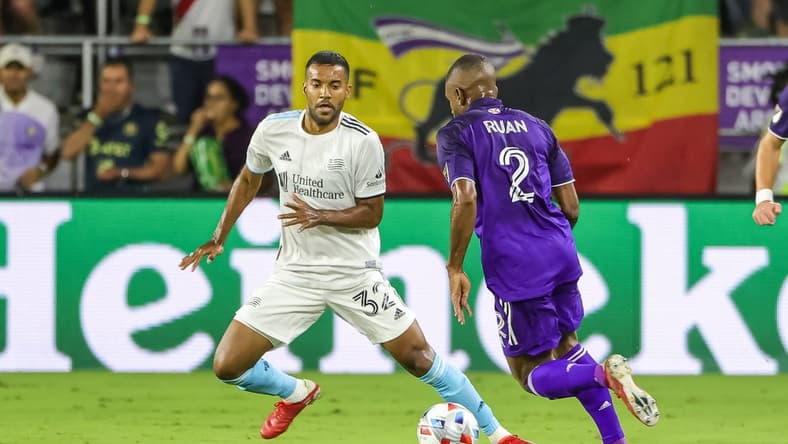 Oct 24, 2021; Orlando, Florida, USA; Orlando City defender Ruan (2) works the ball against New England Revolution defender Christian Mafla (32) during the first half at Orlando City Stadium. Mandatory Credit: Mike Watters-USA TODAY Sports