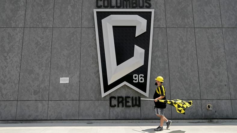 Nick Auddino, of Westerville, walks in front of a Columbus Crew logo on the west side of Lower.com Field before attending the inaugural match between the Columbus Crew and the New England Revolution in Columbus on Saturday, June 1, 2021. Auddino is a longtime Crew supporter who has only missed one game for the birth of his son. His children Jordan, 12, and Laina, 6, Auddino, were attending the match with him.

Ceb Crew 0705 Bjp 01