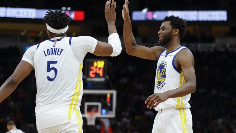 Jan 31, 2022; Houston, Texas, USA; Golden State Warriors center Kevon Looney (5) celebrates with forward Andrew Wiggins (22) after a play during the fourth quarter against the Houston Rockets at Toyota Center. Mandatory Credit: Troy Taormina-USA TODAY Sports