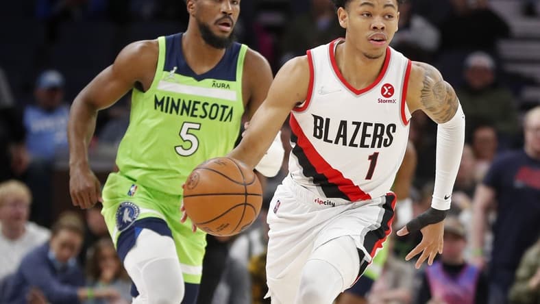 Mar 5, 2022; Minneapolis, Minnesota, USA; Portland Trail Blazers guard Anfernee Simons (1) brings the ball up court past Minnesota Timberwolves guard Malik Beasley (5) in the first quarter at Target Center. Mandatory Credit: Bruce Kluckhohn-USA TODAY Sports