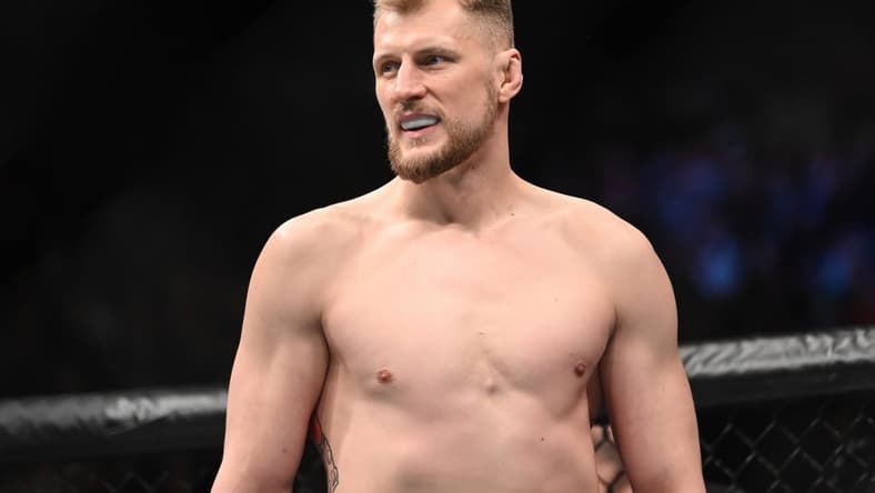 Mar 19, 2022; London, UK; Alexander Volkov (red gloves) and Tom Aspinall (blue gloves) during UFC Fight Night at O2 Arena. Mandatory Credit: Per Haljestam-USA TODAY Sports