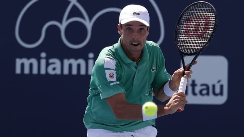 Mar 28, 2022; Miami Gardens, FL, USA; Roberto Bautista Agut (ESP) hits a backhand against Jenson Brooksby (USA)(not pictured) in a third round men's singles match in the Miami Open at Hard Rock Stadium. Mandatory Credit: Geoff Burke-USA TODAY Sports