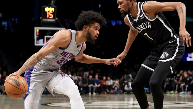 Mar 29, 2022; Brooklyn, New York, USA; Detroit Pistons forward Marvin Bagley III (35) controls the ball against Brooklyn Nets forward Kevin Durant (7) during the first quarter at Barclays Center. Mandatory Credit: Brad Penner-USA TODAY Sports