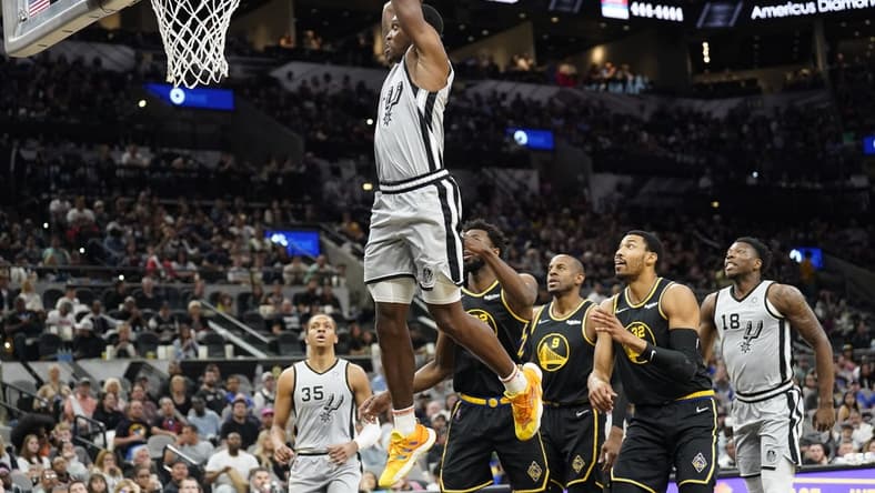 Apr 9, 2022; San Antonio, Texas, USA; San Antonio Spurs guard Lonnie Walker IV (1) dunks against the Golden State Warriors during the first half at AT&T Center. Mandatory Credit: Scott Wachter-USA TODAY Sports