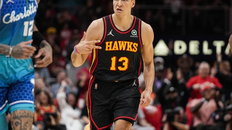 Apr 13, 2022; Atlanta, Georgia, USA; Atlanta Hawks guard Bogdan Bogdanovic (13) reacts after making a three point shot against the Charlotte Hornets during the first half at State Farm Arena. Mandatory Credit: Dale Zanine-USA TODAY Sports