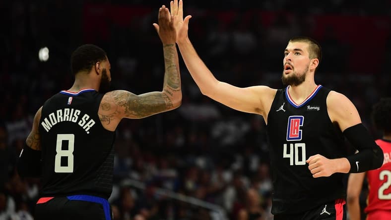 Apr 15, 2022; Los Angeles, California, USA; Los Angeles Clippers center Ivica Zubac (40) is greeted by forward Marcus Morris Sr. (8) against the New Orleans Pelicans during the first half of the play in game at Crypto.com Arena. Mandatory Credit: Gary A. Vasquez-USA TODAY Sports