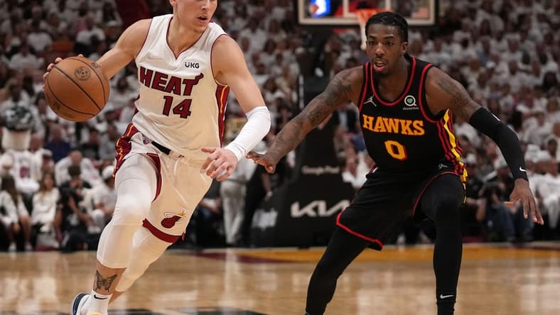 Apr 19, 2022; Miami, Florida, USA; Miami Heat guard Tyler Herro (14) drives the ball around Atlanta Hawks guard Delon Wright (0) during the first half in game two of the first round for the 2022 NBA playoffs at FTX Arena. Mandatory Credit: Jasen Vinlove-USA TODAY Sports