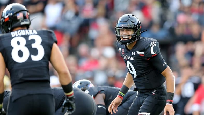 Cincinnati Bearcats quarterback Desmond Ridder (9) instructs Cincinnati Bearcats tight end Josiah Deguara (83) in the first quarter of an NCAA football game against the UCLA Bruins, Thursday, Aug. 29, 2019, at Nippert Stadium in Cincinnati.Ucla Bruins At Cincinnati Bearcats Aug 29