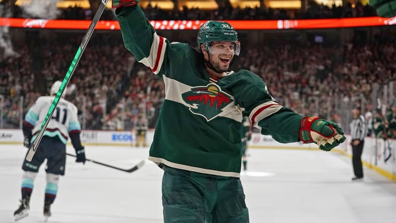 Apr 22, 2022; Saint Paul, Minnesota, USA; Minnesota Wild left wing Kevin Fiala (22) celebrates his fifth assist of the night against the Seattle Kraken on a goal scored by Minnesota Wild forward Nicolas Deslauriers (not pictured) during the second period at Xcel Energy Center. Mandatory Credit: Nick Wosika-USA TODAY Sports