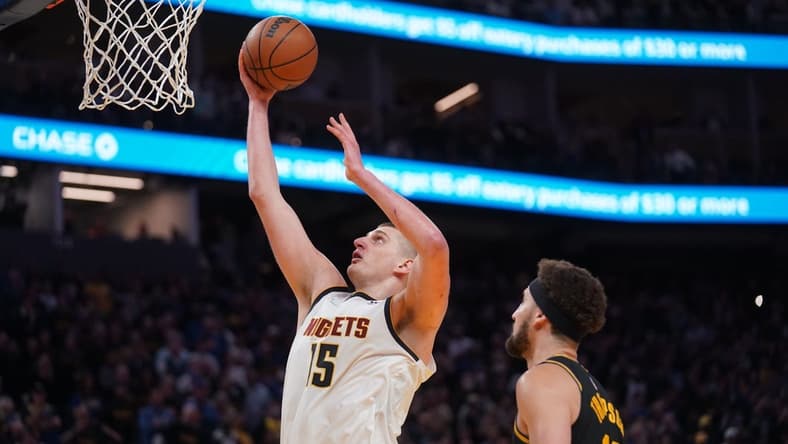 Apr 27, 2022; San Francisco, California, USA; Denver Nuggets center Nikola Jokic (15) makes a basket in front of Golden State Warriors guard Klay Thompson (11) in the fourth quarter during game five of the first round for the 2022 NBA playoffs at Chase Center. Mandatory Credit: Cary Edmondson-USA TODAY Sports