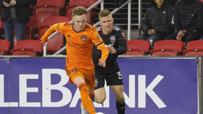 May 7, 2022; Washington, District of Columbia, USA; Houston Dynamo forward Tyler Pasher (19) dribbles the ball as D.C. United defender Julian Gressel (31) chases in the first half at Audi Field. Mandatory Credit: Geoff Burke-USA TODAY Sports