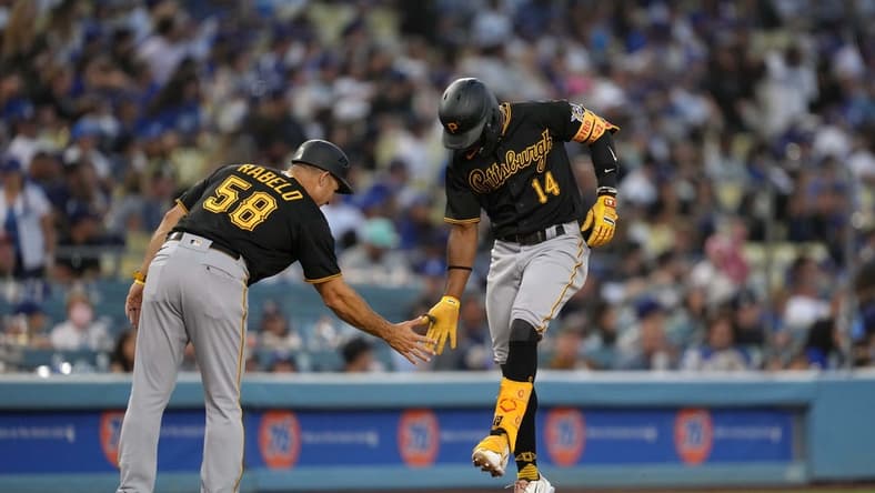 Jun 1, 2022; Los Angeles, California, USA; Pittsburgh Pirates shortstop Rodolfo Castro (14) celebrates with third base coach Mike Rabelo (58) after hitting a two-run home run in the eighth inning against the Los Angeles Dodgers at Dodger Stadium. Mandatory Credit: Kirby Lee-USA TODAY Sports