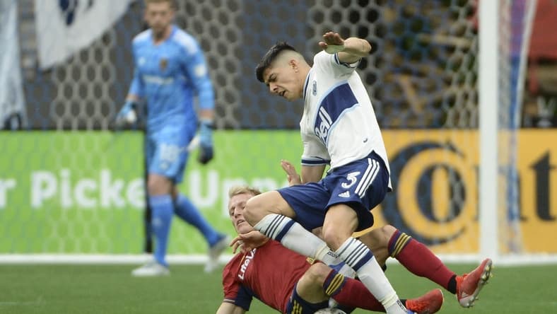 Jun 4, 2022; Vancouver, British Columbia, CAN;  Real Salt Lake defender Jasper Loffelsend (28) challenges Vancouver Whitecaps defender Cristian Gutierrez (3) during the first half at BC Place. Mandatory Credit: Anne-Marie Sorvin-USA TODAY Sports
