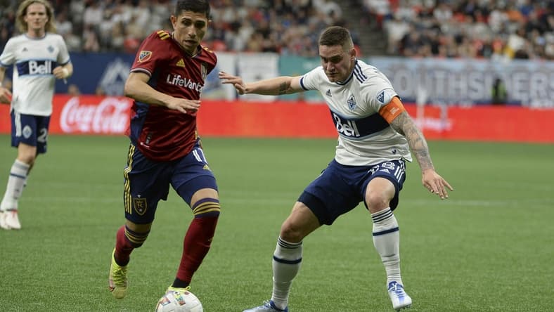 Jun 4, 2022; Vancouver, British Columbia, CAN;  Real Salt Lake forward Jefferson Savarino (11) dribbles the ball against Vancouver Whitecaps defender Jake Nerwinski (28) during the second half at BC Place. Mandatory Credit: Anne-Marie Sorvin-USA TODAY Sports