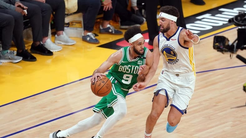 Jun 5, 2022; San Francisco, California, USA; Boston Celtics guard Derrick White (9) dribbles against Golden State Warriors guard Klay Thompson (11) in the second quarter during game two of the 2022 NBA Finals at Chase Center. Mandatory Credit: Cary Edmondson-USA TODAY Sports
