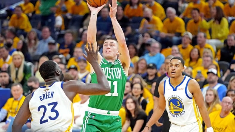 Jun 5, 2022; San Francisco, California, USA; Boston Celtics guard Payton Pritchard (11) shoots the ball against Golden State Warriors forward Draymond Green (23) during game two of the 2022 NBA Finals at Chase Center. Mandatory Credit: Kyle Terada-USA TODAY Sports