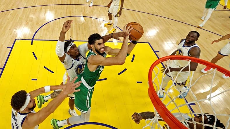 Jun 5, 2022; San Francisco, California, USA; Boston Celtics forward Jayson Tatum (0) shoots the ball against Golden State Warriors center Kevon Looney (5) during game two of the 2022 NBA Finals at Chase Center. Mandatory Credit: Jed Jacobsohn/pool photo-USA TODAY Sports