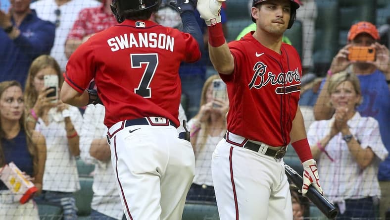 Jun 10, 2022; Atlanta, Georgia, USA; Atlanta Braves shortstop Dansby Swanson (7) celebrates after a two-run home run with third baseman Austin Riley (27) against the Pittsburgh Pirates in the third inning at Truist Park. Mandatory Credit: Brett Davis-USA TODAY Sports