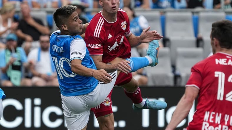 Jun 11, 2022; Charlotte, North Carolina, USA; New York Red Bulls defender Sean Nealis (15) after a header against Charlotte FC forward Cristian Ortiz (10) during first half action at Bank of America Stadium. Mandatory Credit: Jim Dedmon-USA TODAY Sports