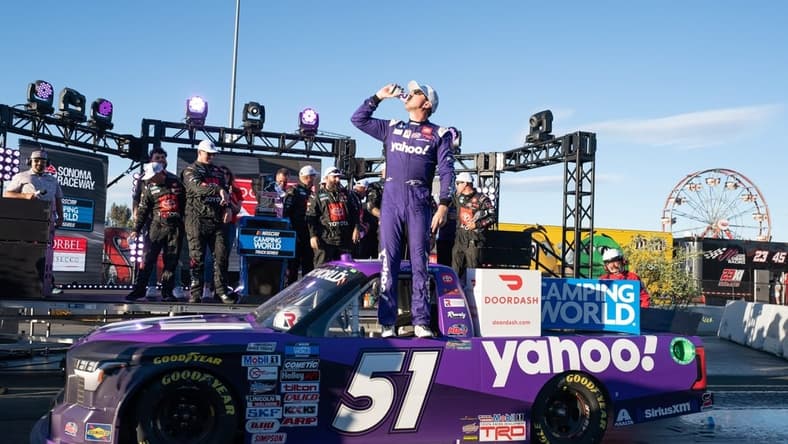 Jun 11, 2022; Sonoma, California, USA;  NASCAR Truck Series driver Kyle Busch (51) celebrates with his team after winning the NASCAR Truck Series DoorDash 250 at Sonoma Raceway. Mandatory Credit: Stan Szeto-USA TODAY Sports