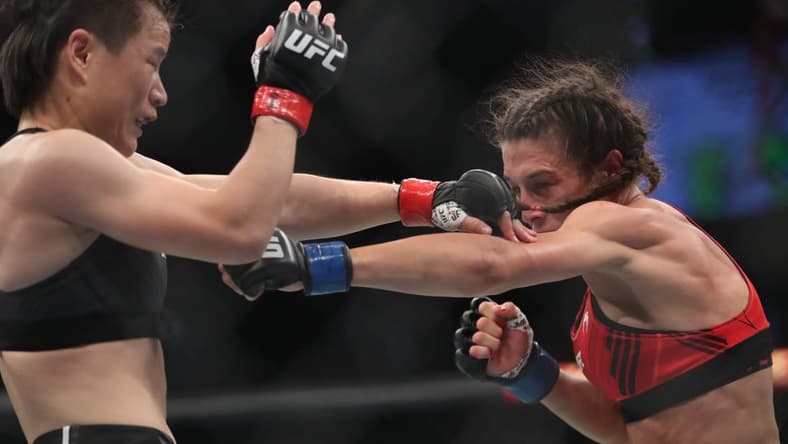 Jun 12, 2022; Singapore, SIN; Zhang Weili (red gloves) fights Joanna Jedrzejczyk (blue gloves) during UFC 275 at Singapore Indoor Stadium. Mandatory Credit: Paul Miller-USA TODAY Sports