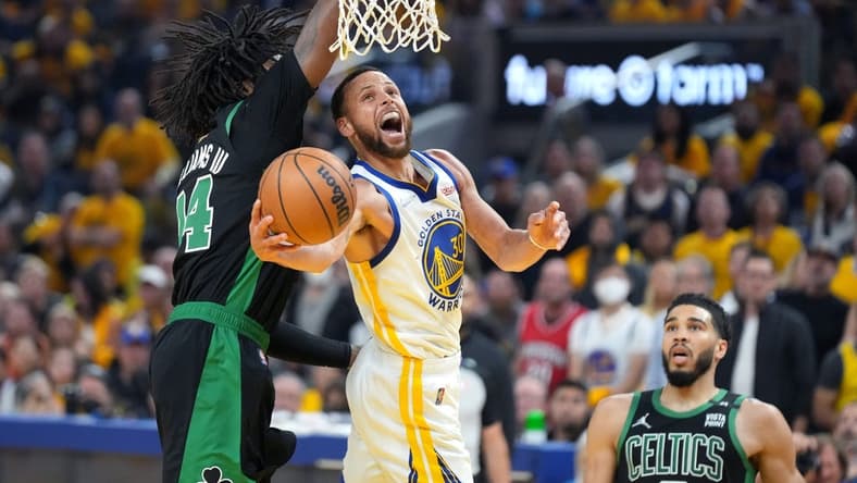 Jun 13, 2022; San Francisco, California, USA; Golden State Warriors guard Stephen Curry (30) goes to the basket while defended by Boston Celtics center Robert Williams III (44) during the first half in game five of the 2022 NBA Finals at Chase Center. Mandatory Credit: Kyle Terada-USA TODAY Sports