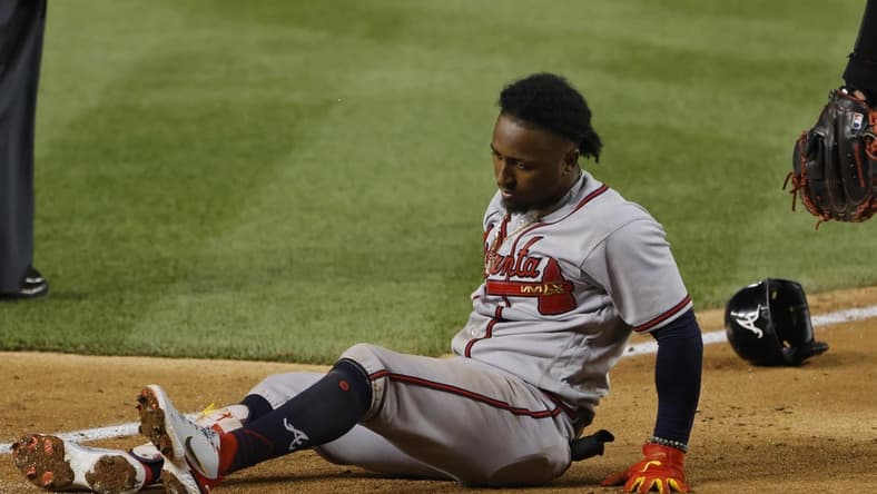 Jun 13, 2022; Washington, District of Columbia, USA; Atlanta Braves third baseman Ozzie Albies (1) sits at the batter's box after being injured while batting against the Washington Nationals during the fifth inning at Nationals Park. Mandatory Credit: Geoff Burke-USA TODAY Sports