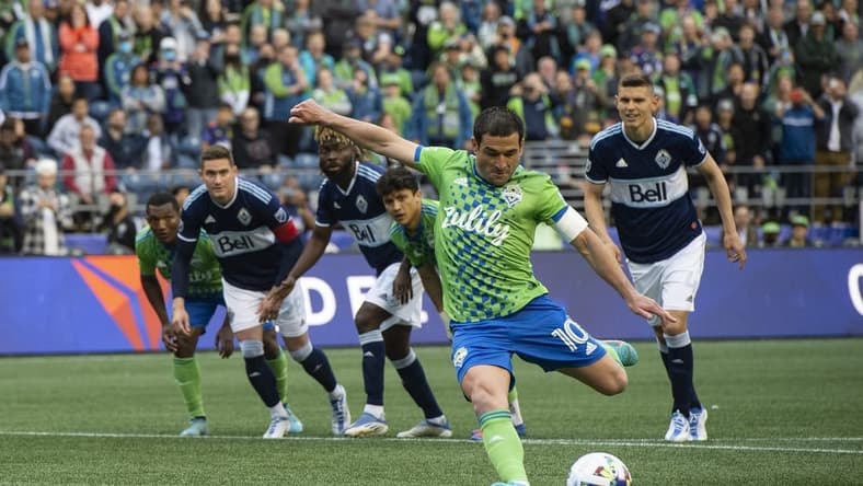 Jun 14, 2022; Seattle, Washington, USA; Seattle Sounders midfielder Nicolas Lodeiro (10) scores a penalty kick during the first half against the Vancouver Whitecaps at Lumen Field. Mandatory Credit: Michael Thomas Shroyer-USA TODAY Sports