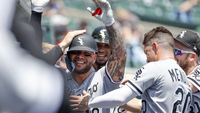 Jun 15, 2022; Detroit, Michigan, USA; Chicago White Sox third baseman Yoan Moncada (10) receives congratulations from teammatesnafter after he hit a three run home run against the Detroit Tigers in the first inning at Comerica Park. Mandatory Credit: Rick Osentoski-USA TODAY Sports