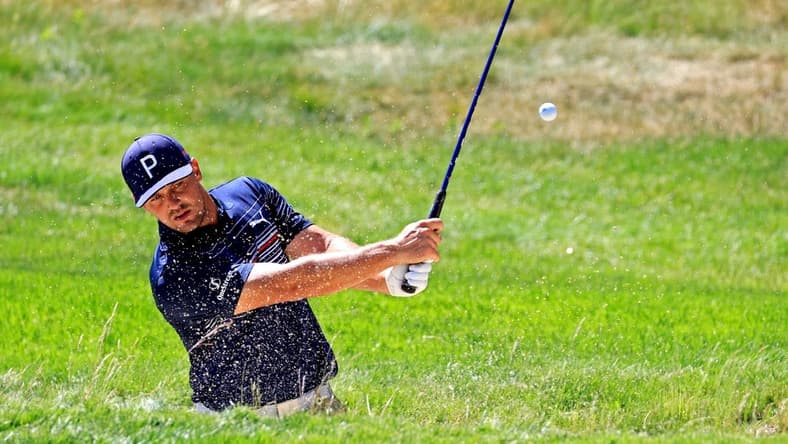 Jun 15, 2022; Brookline, Massachusetts, USA; Bryson DeChambeau plays a shot from a bunker on the 14th hole during a practice round of the U.S. Open golf tournament at The Country Club. Mandatory Credit: Aaron Doster-USA TODAY Sports